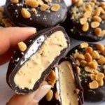 Finished chocolate peanut butter bites beautifully plated with sea salt and sprinkles on a white tray
