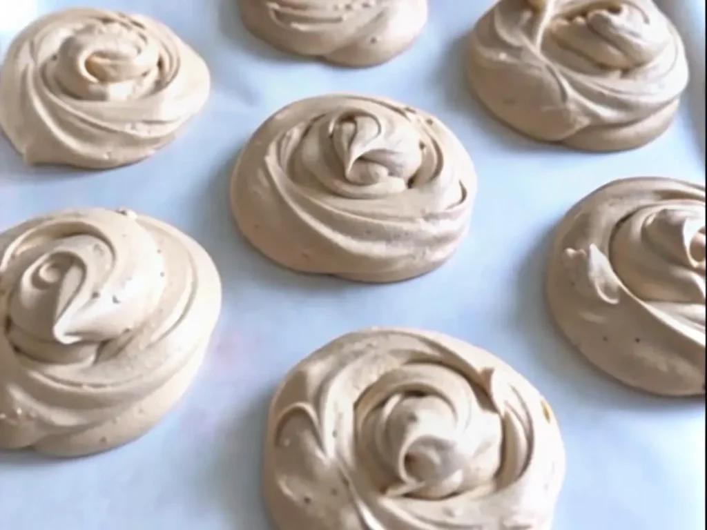 Step-by-step preparation of chocolate peanut butter bites with hands rolling dough balls on parchment paper